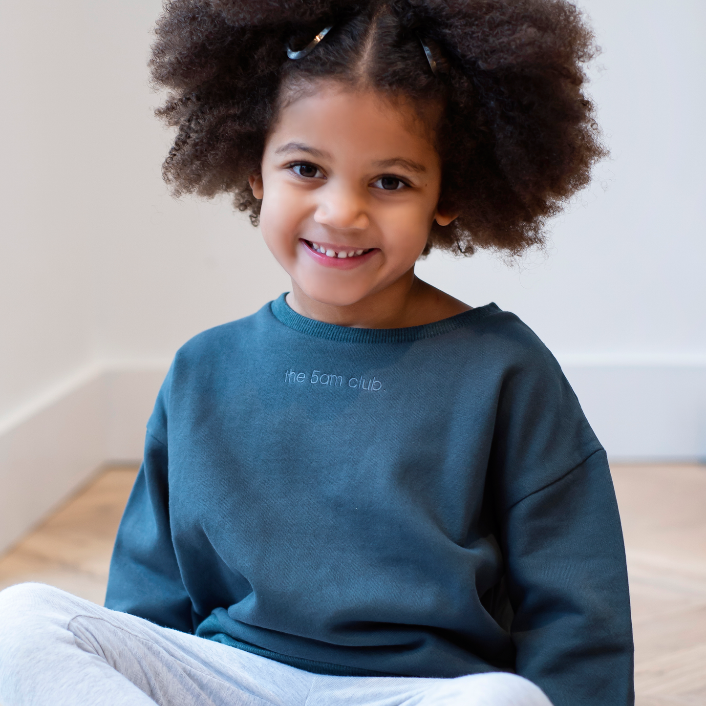 charcoal kids sweatshirt with the 5am club logo on the chest