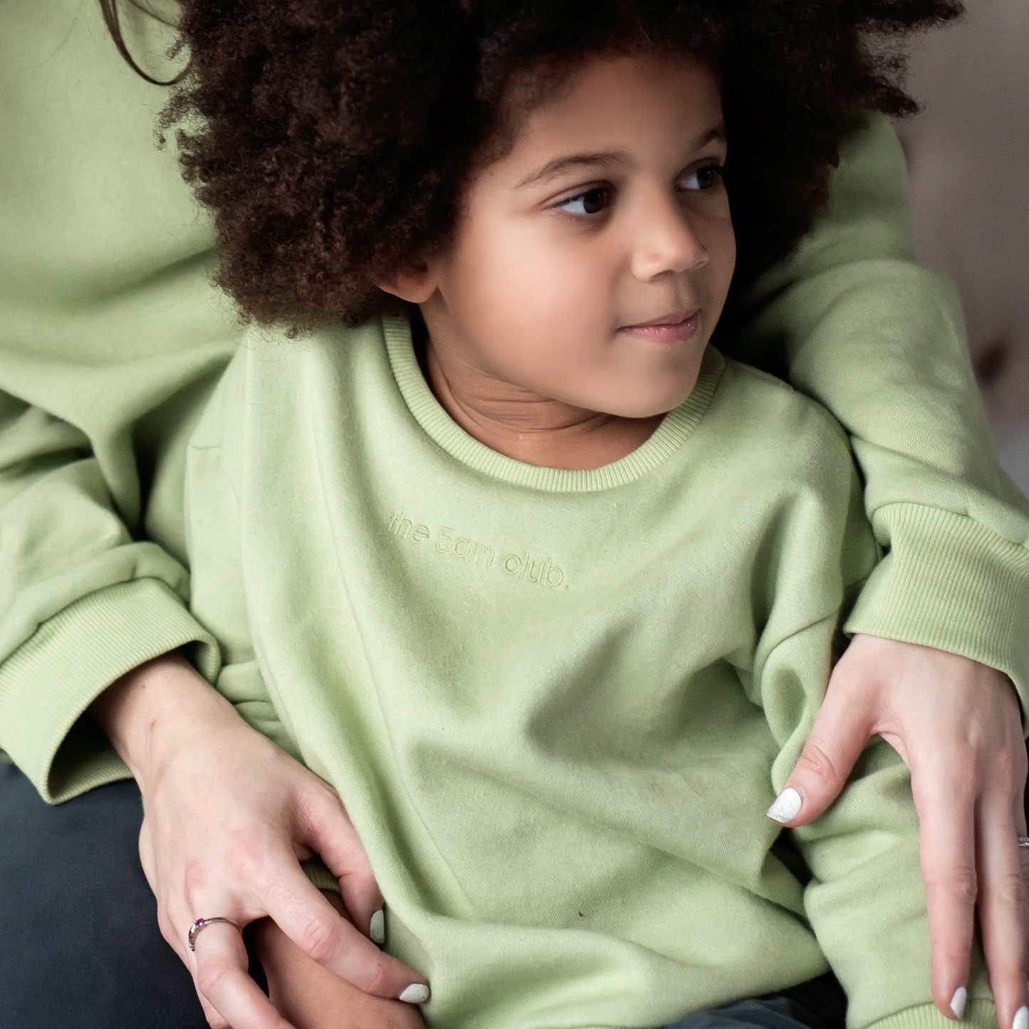 sage green kids sweatshirt with the 5am club logo on the chest