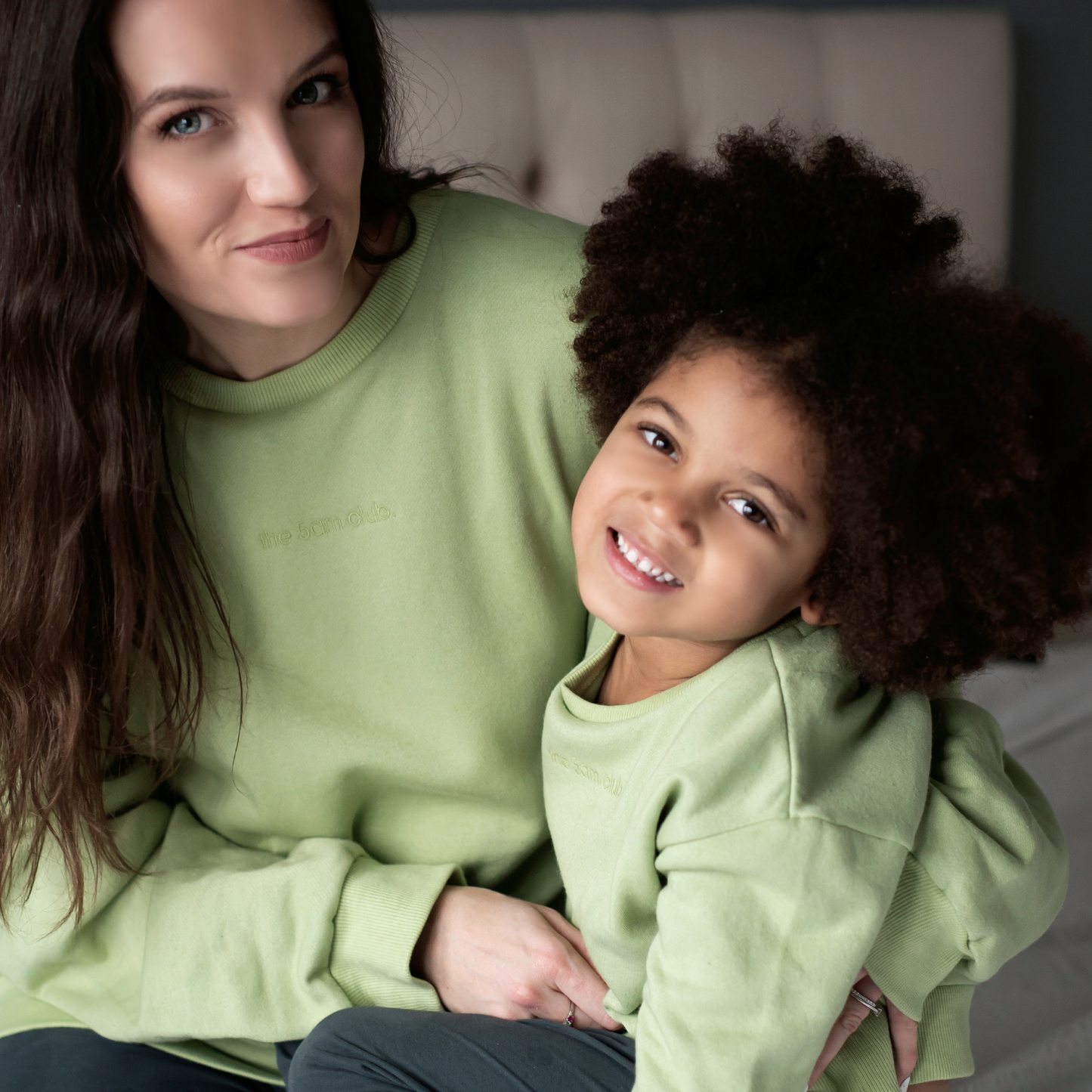 sage green kids sweatshirt with the 5am club logo on the chest