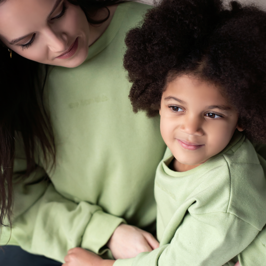 sage green kids sweatshirt with the 5am club logo on the chest