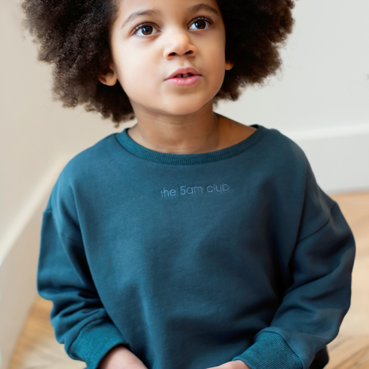 charcoal kids sweatshirt with the 5am club logo on the chest