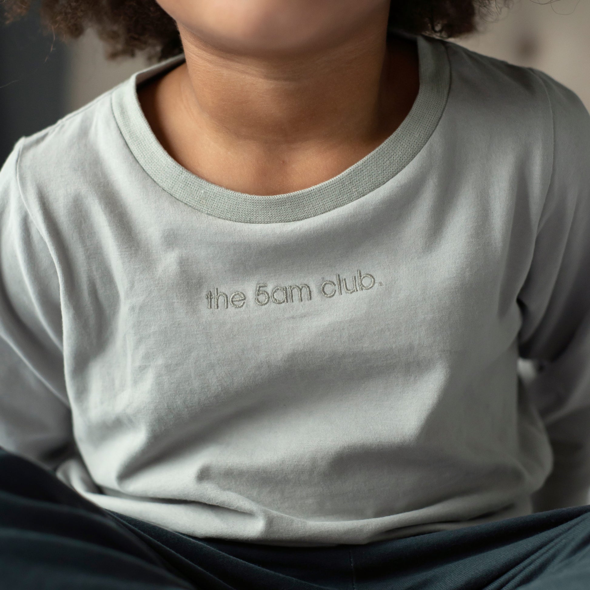 light grey long sleeve top from the 5am mama. The 5am club logo on the chest