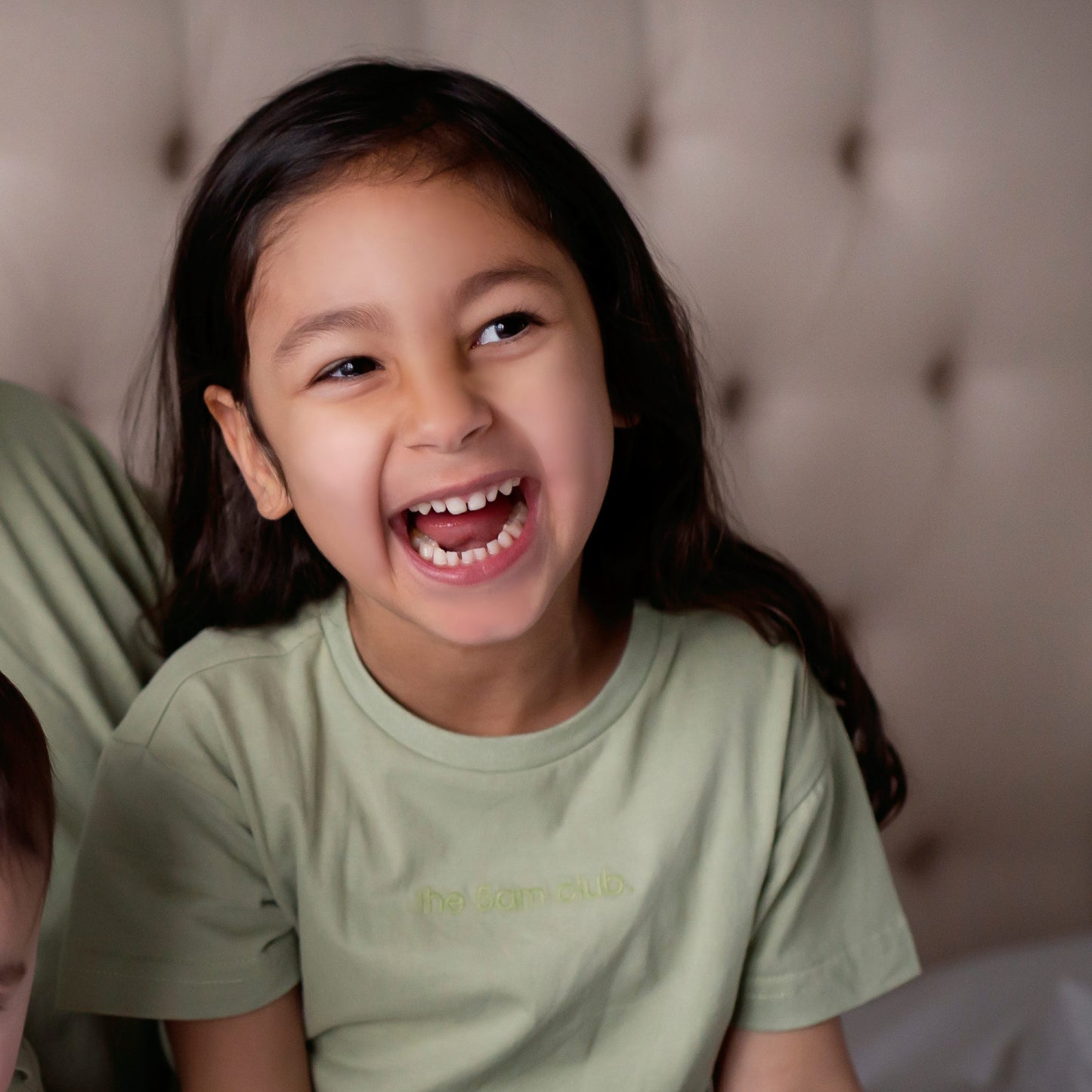 sage green kids t-shirt with the 5am club logo on the chest