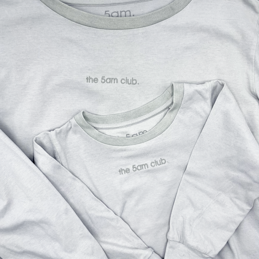 light grey long sleeve top from the 5am mama. The 5am club logo on the chest